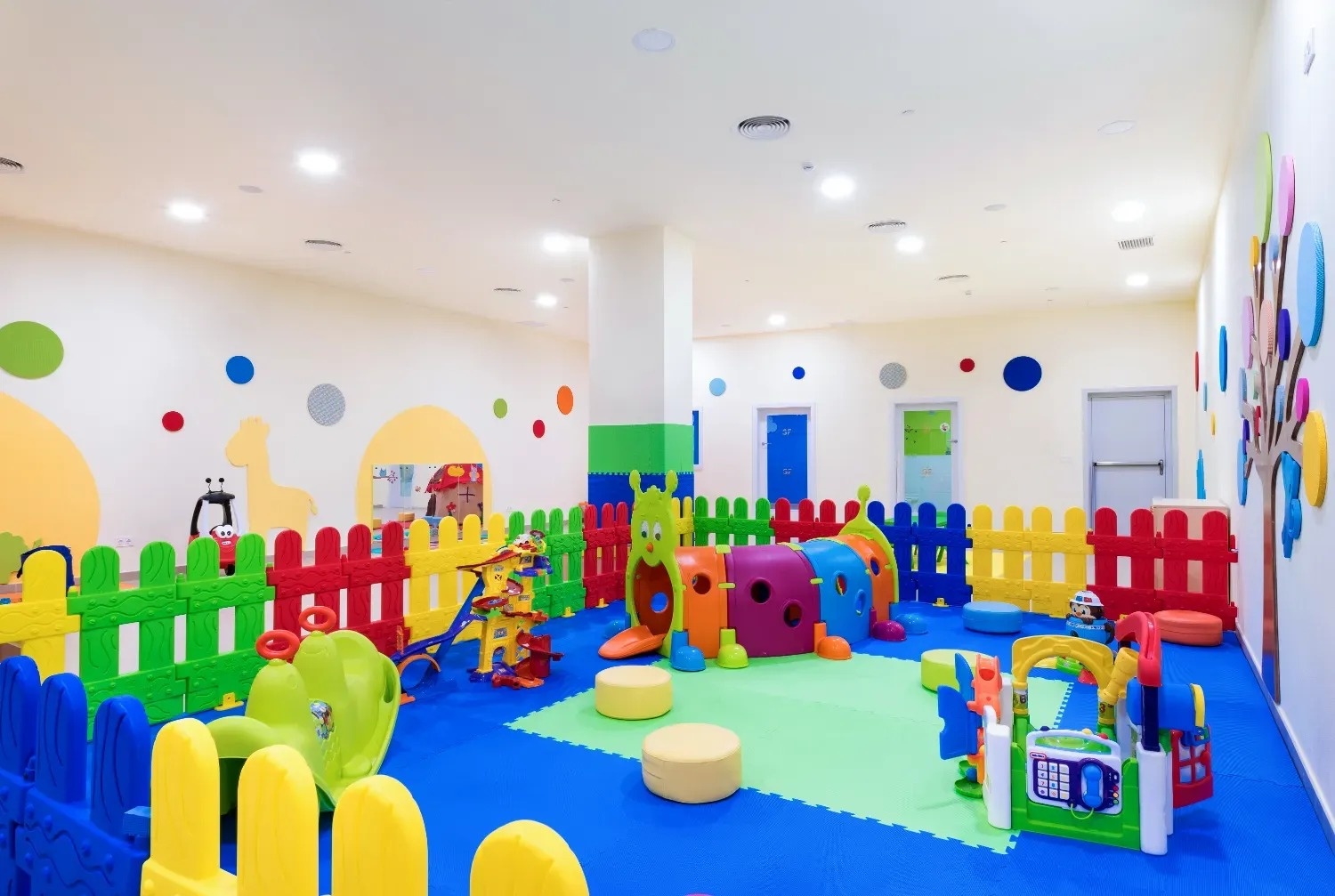 a large room with lots of colorful toys and fences