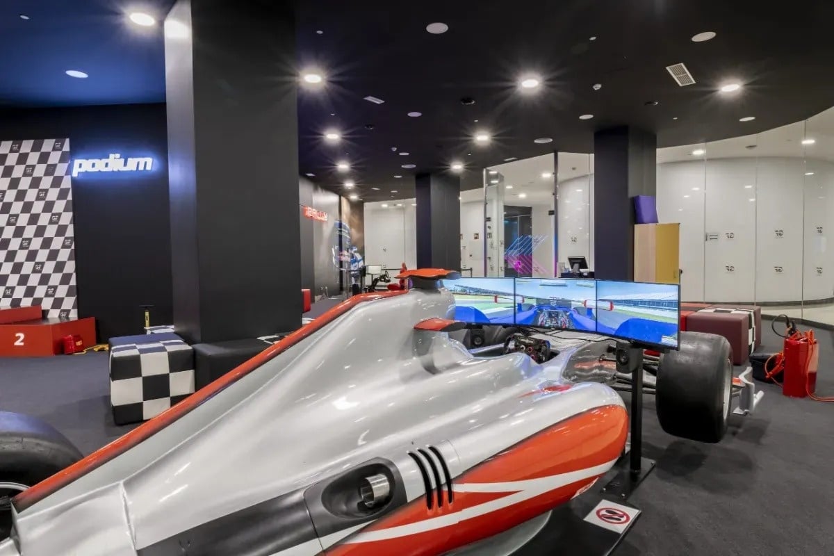 a race car is in a room with a sign that says the podium