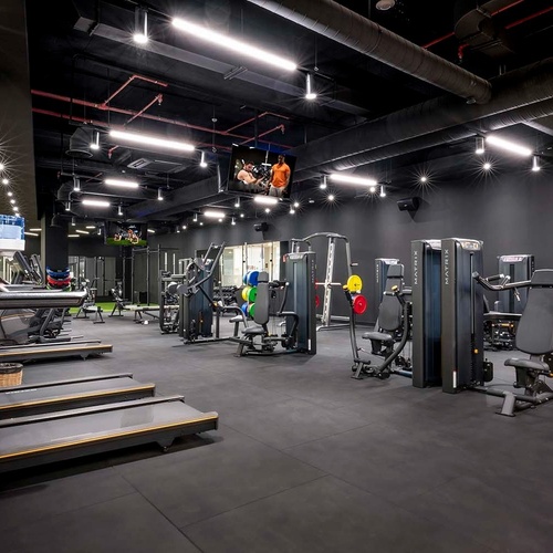 un gimnasio con muchas máquinas y una cinta de correr que dice matrix