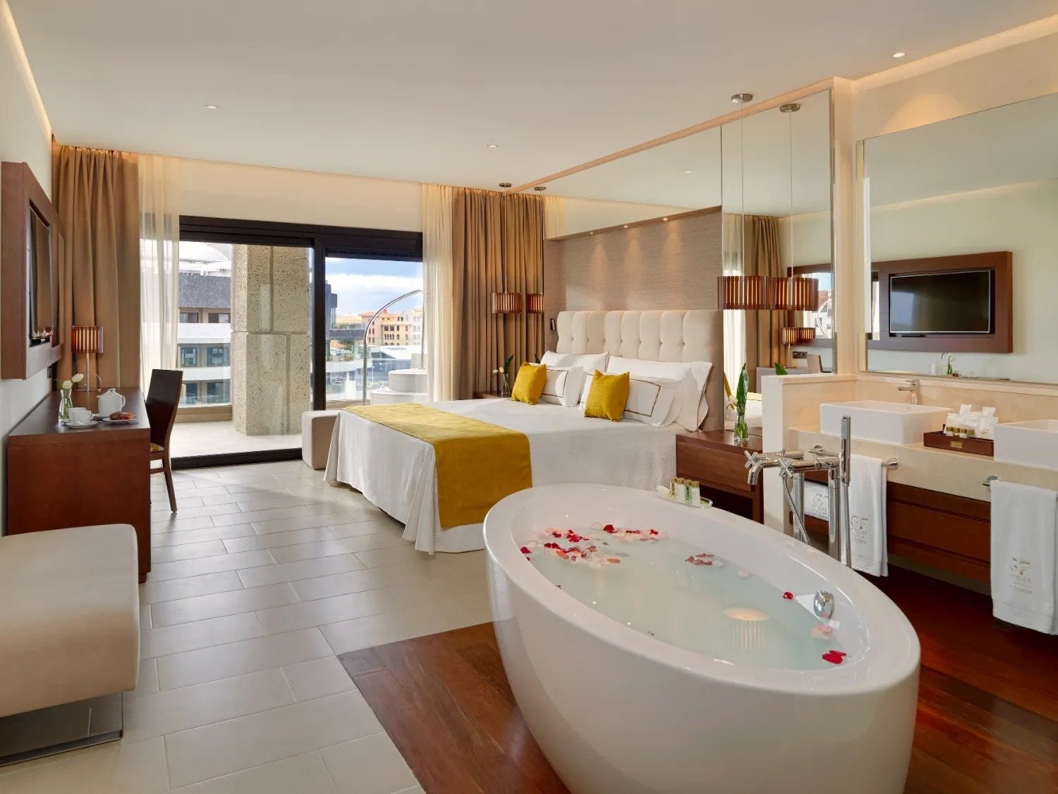 a hotel room with a bathtub and a bed