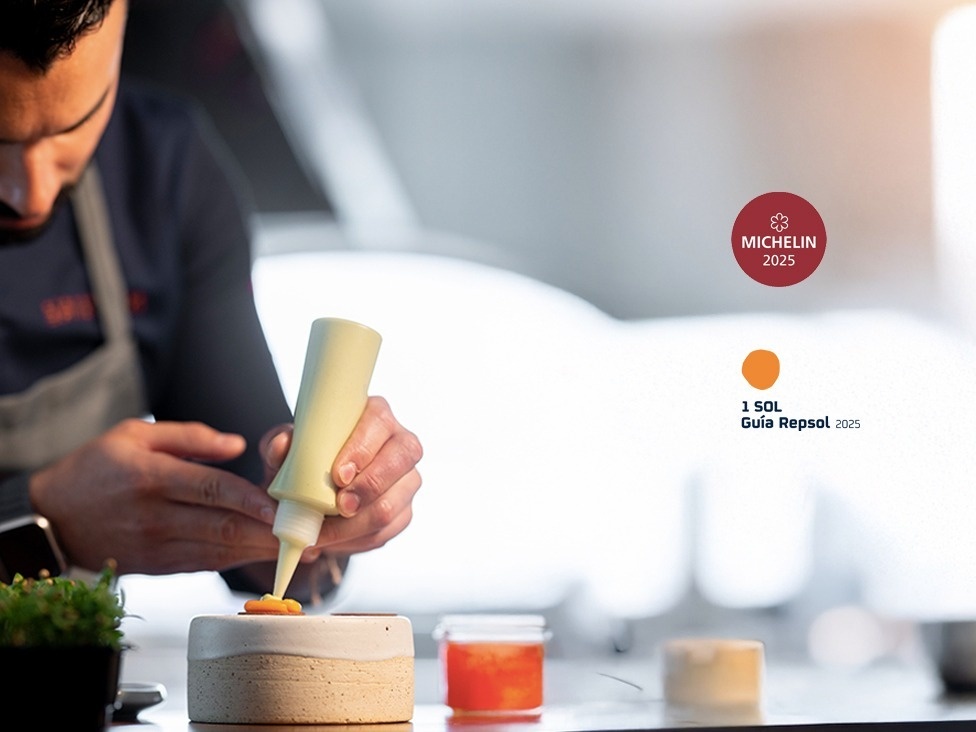 an aerial view of a sandy beach with blue water