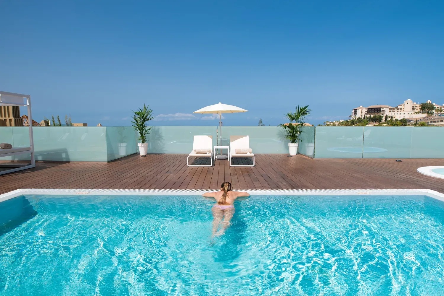 a woman in a pink bikini is floating in a swimming pool