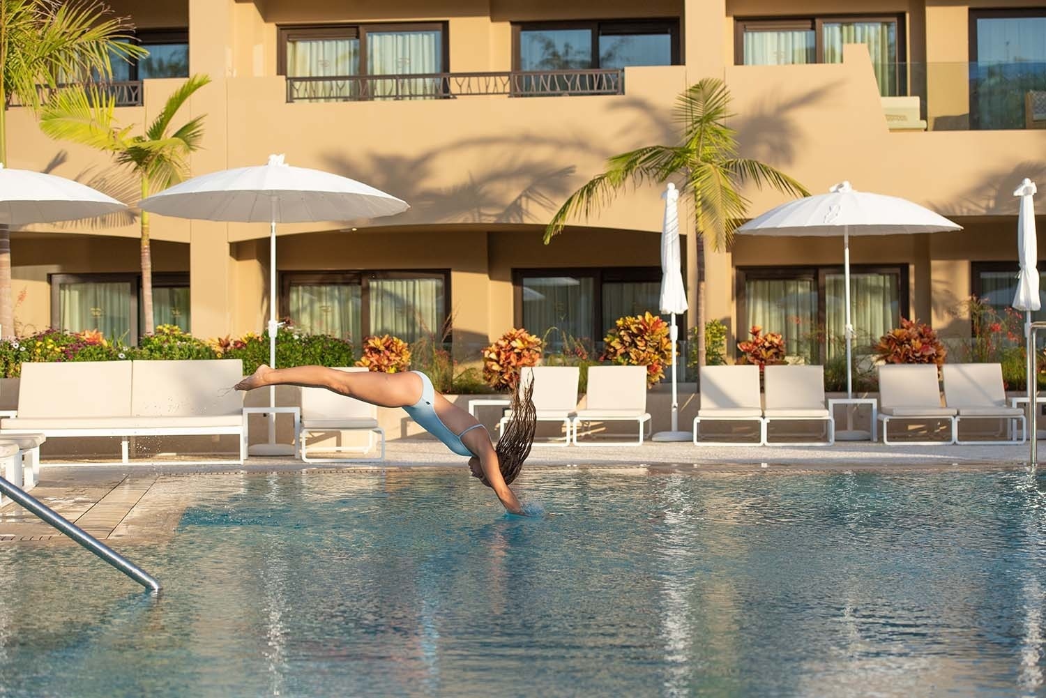 an aerial view of a city with a swimming pool in the middle