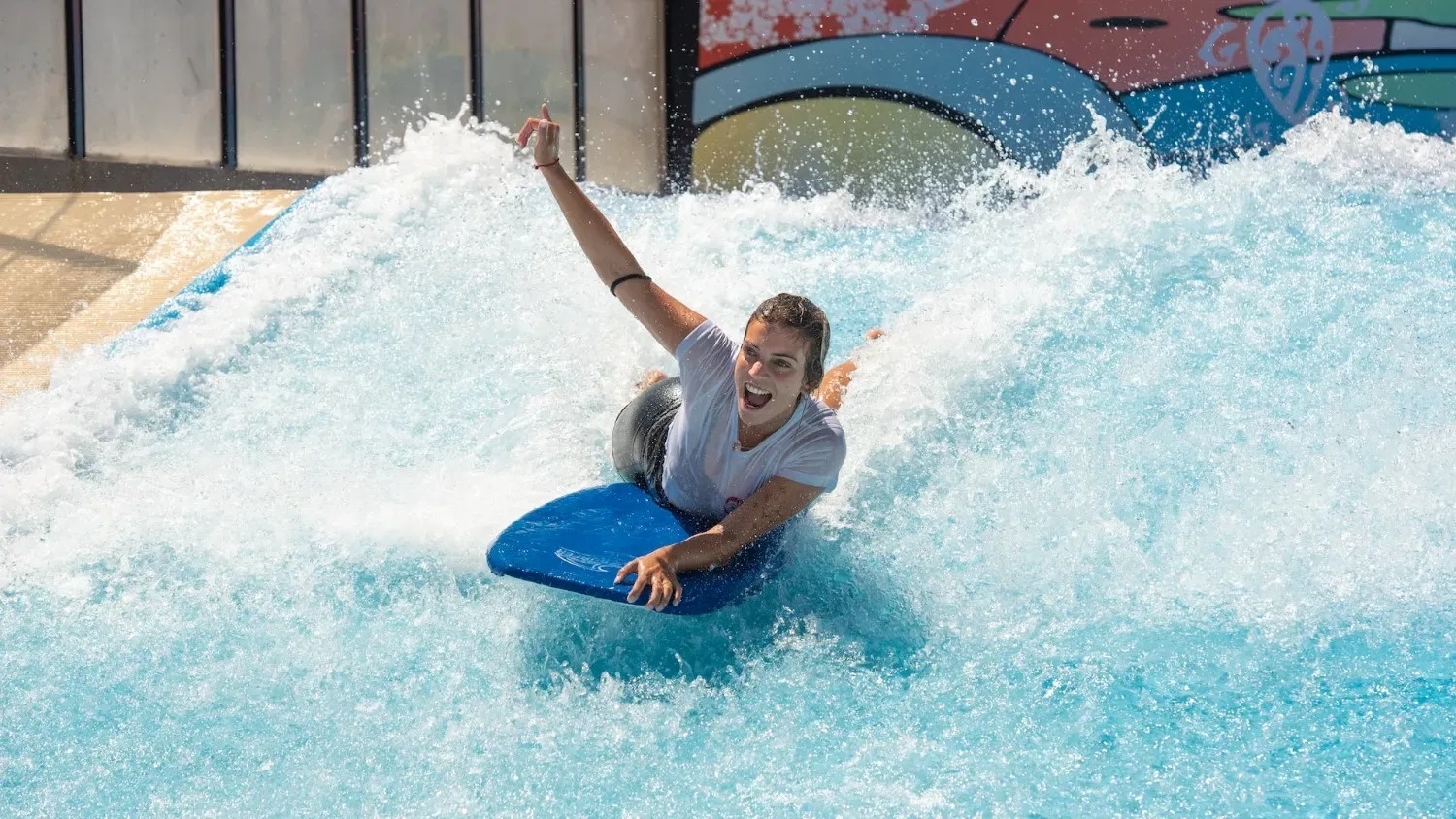 a woman is riding a wave on a boogie board