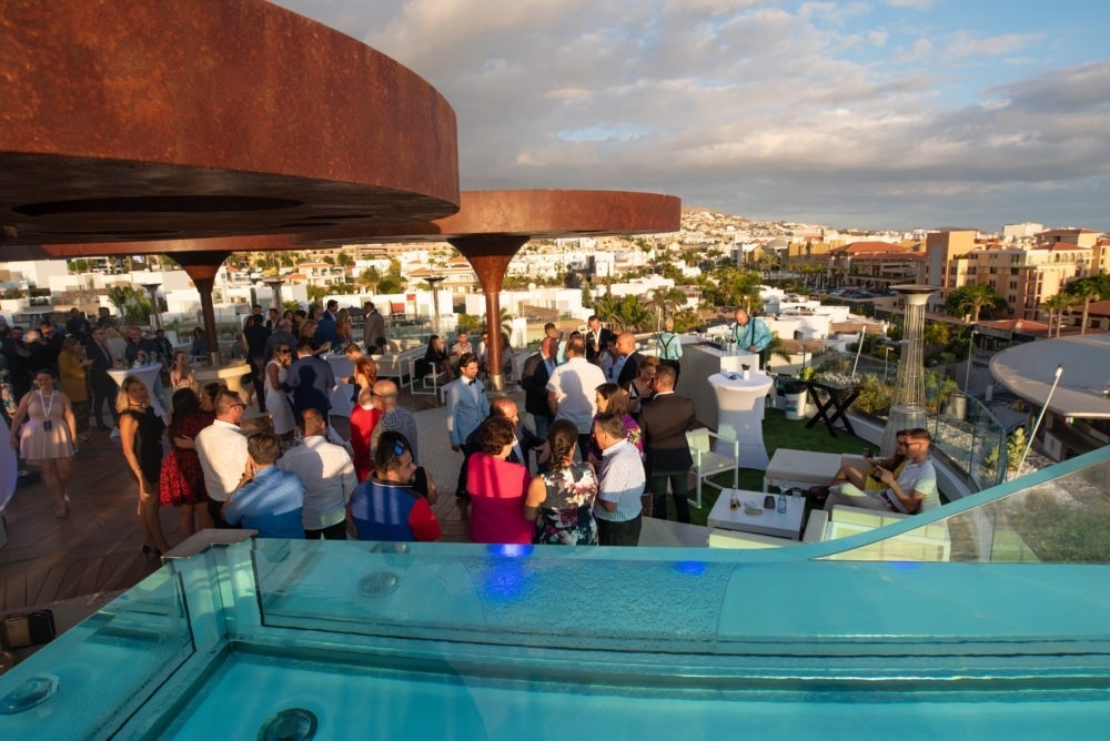 a beach at sunset with buildings in the background