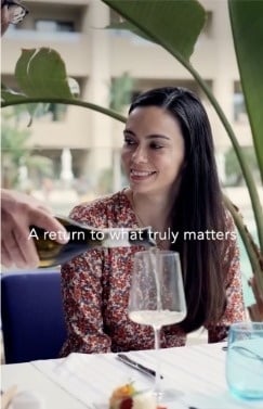 an aerial view of a sandy beach with blue water