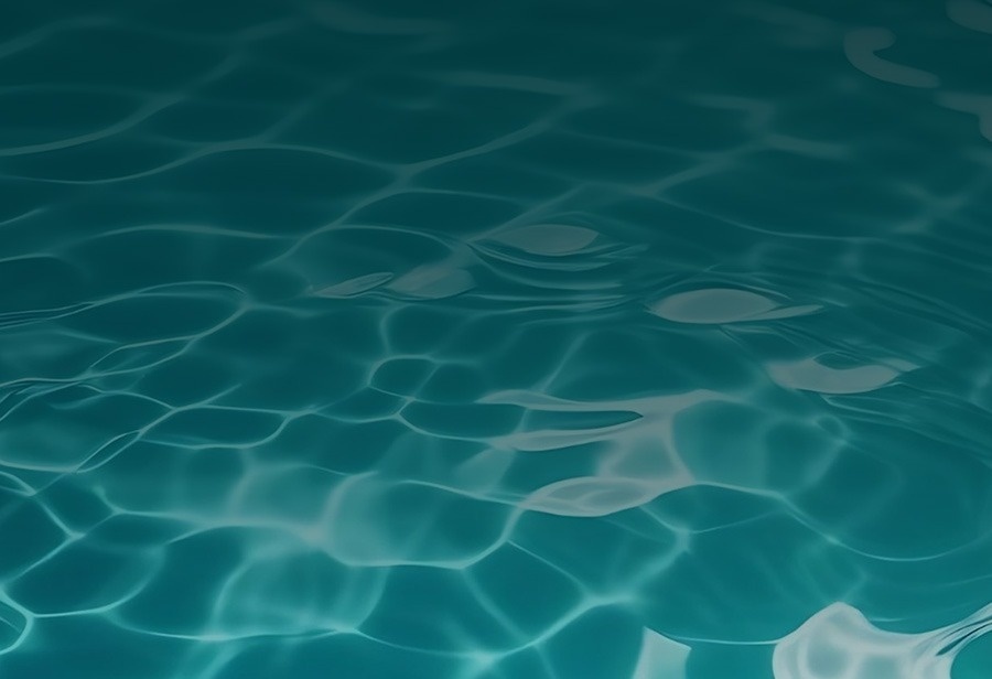 a close up of a blue water surface with waves