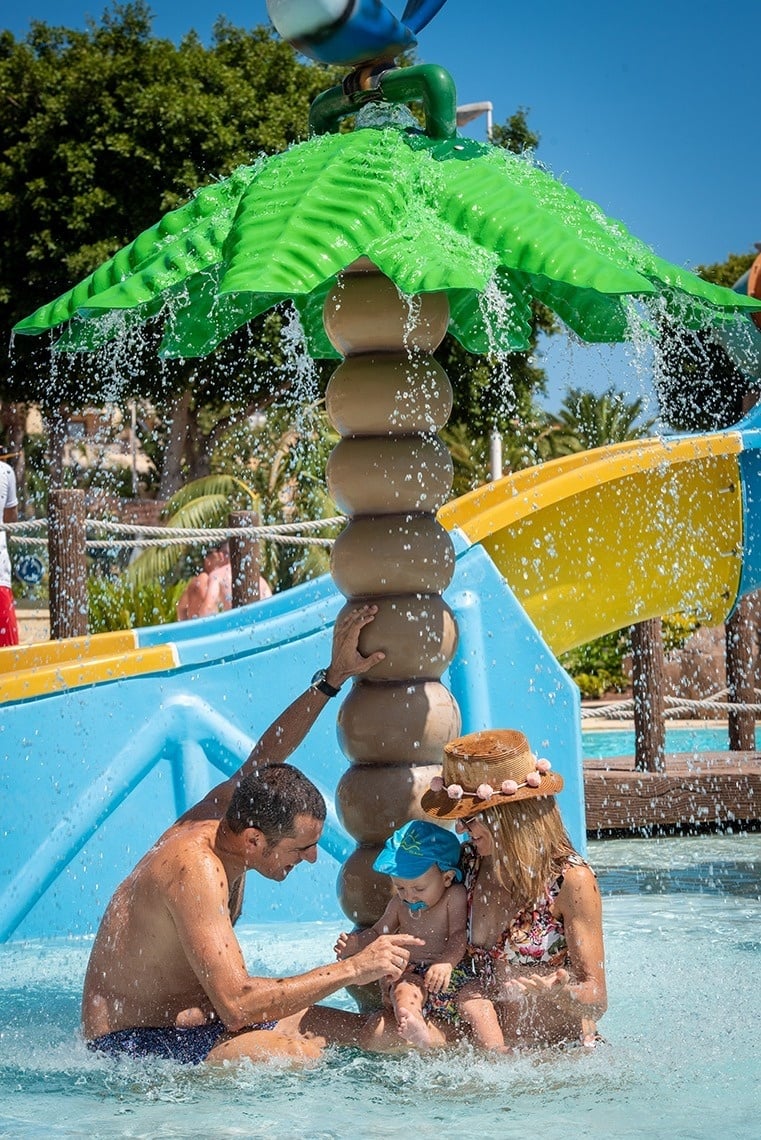 an aerial view of a sandy beach with blue water