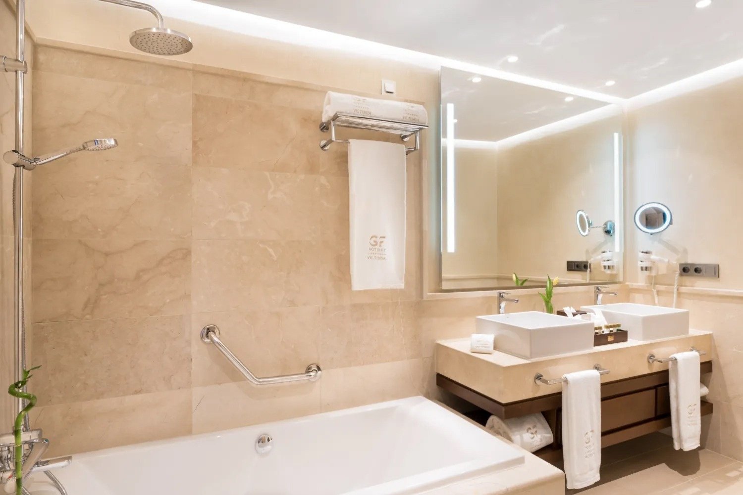 a bathroom with two sinks and a towel that says 15 hotel