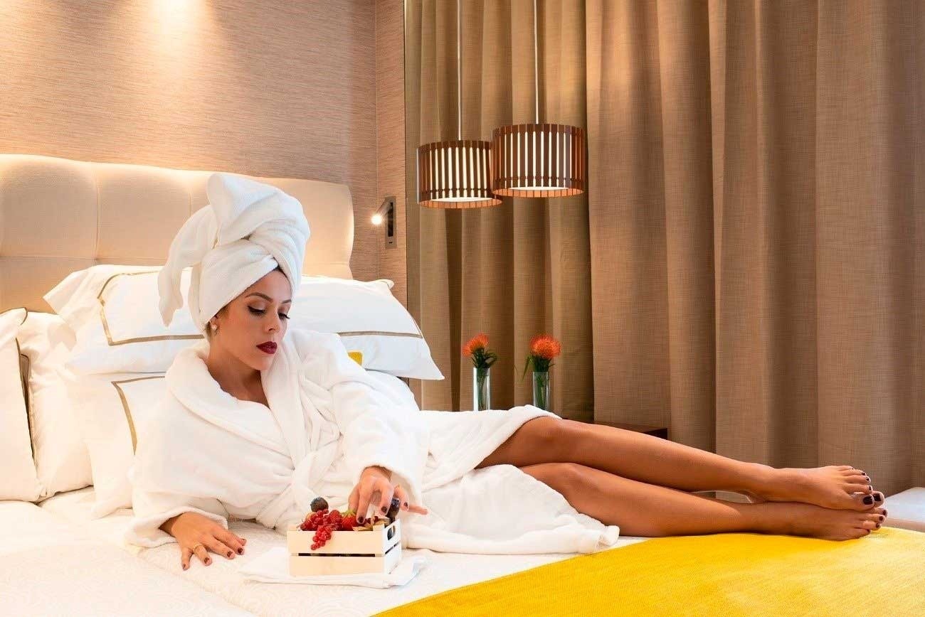 a beach at sunset with buildings in the background