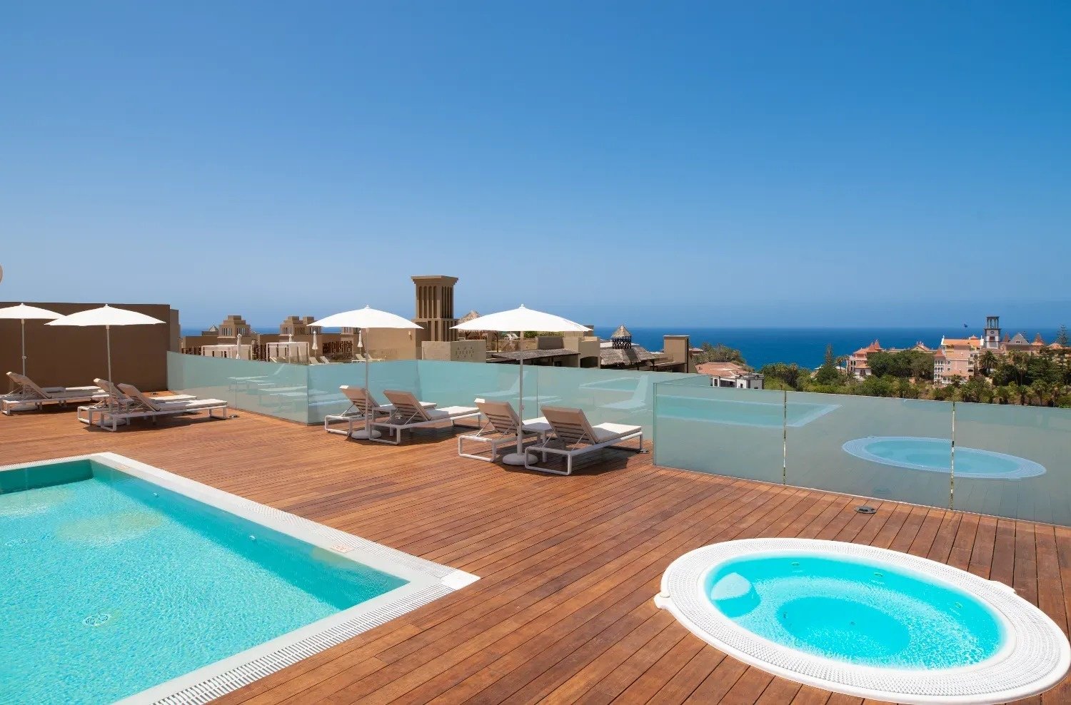 a swimming pool with umbrellas and chairs around it
