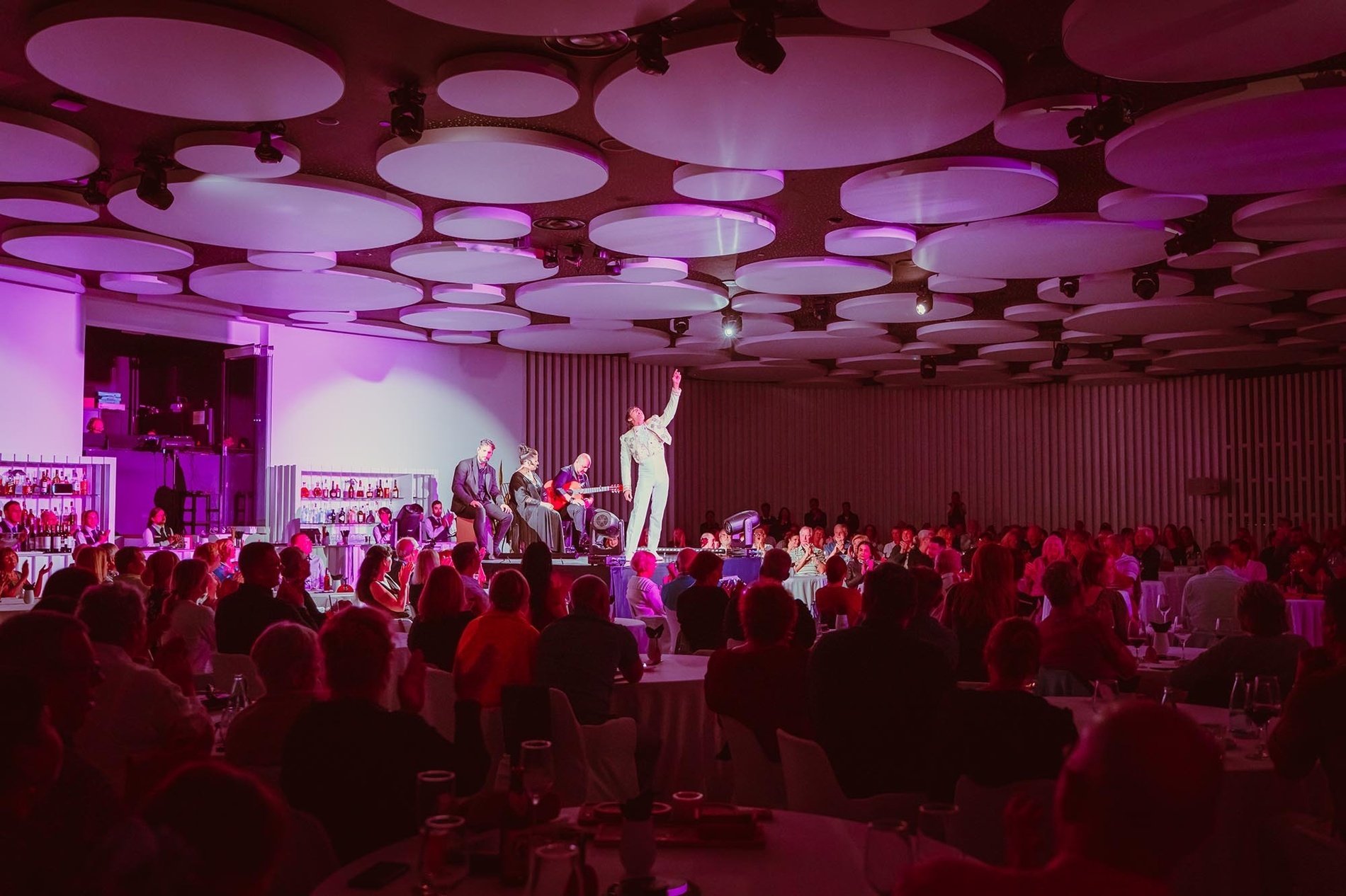 a woman in a red dress sings in front of a sign that says scandal