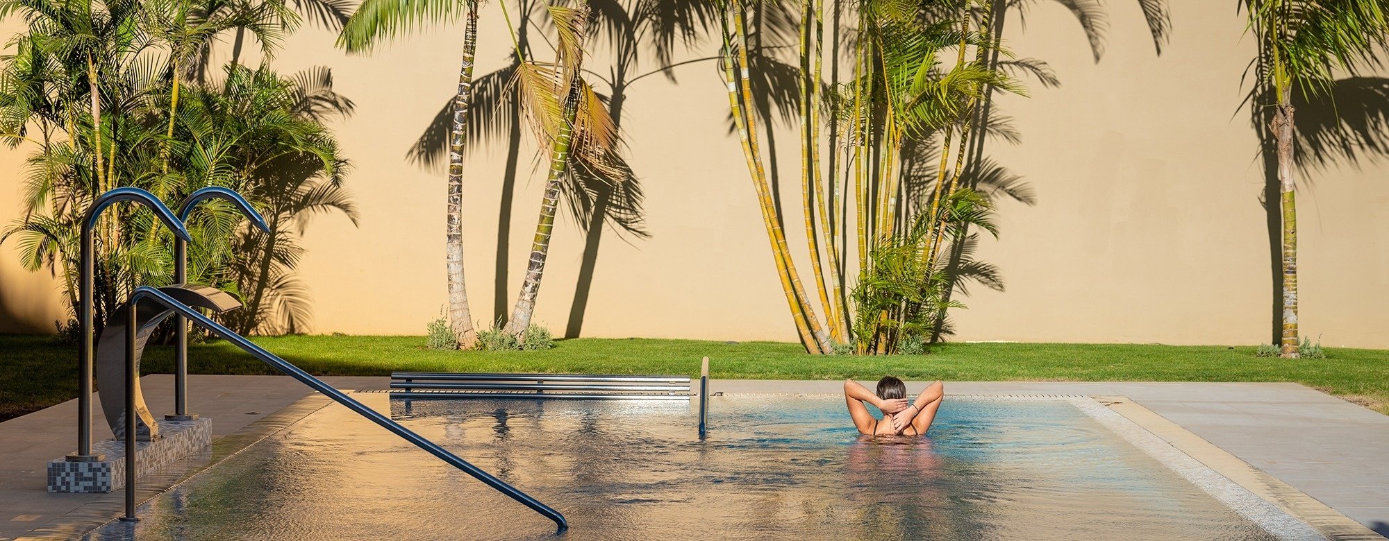 a woman is getting a massage with candles in the background