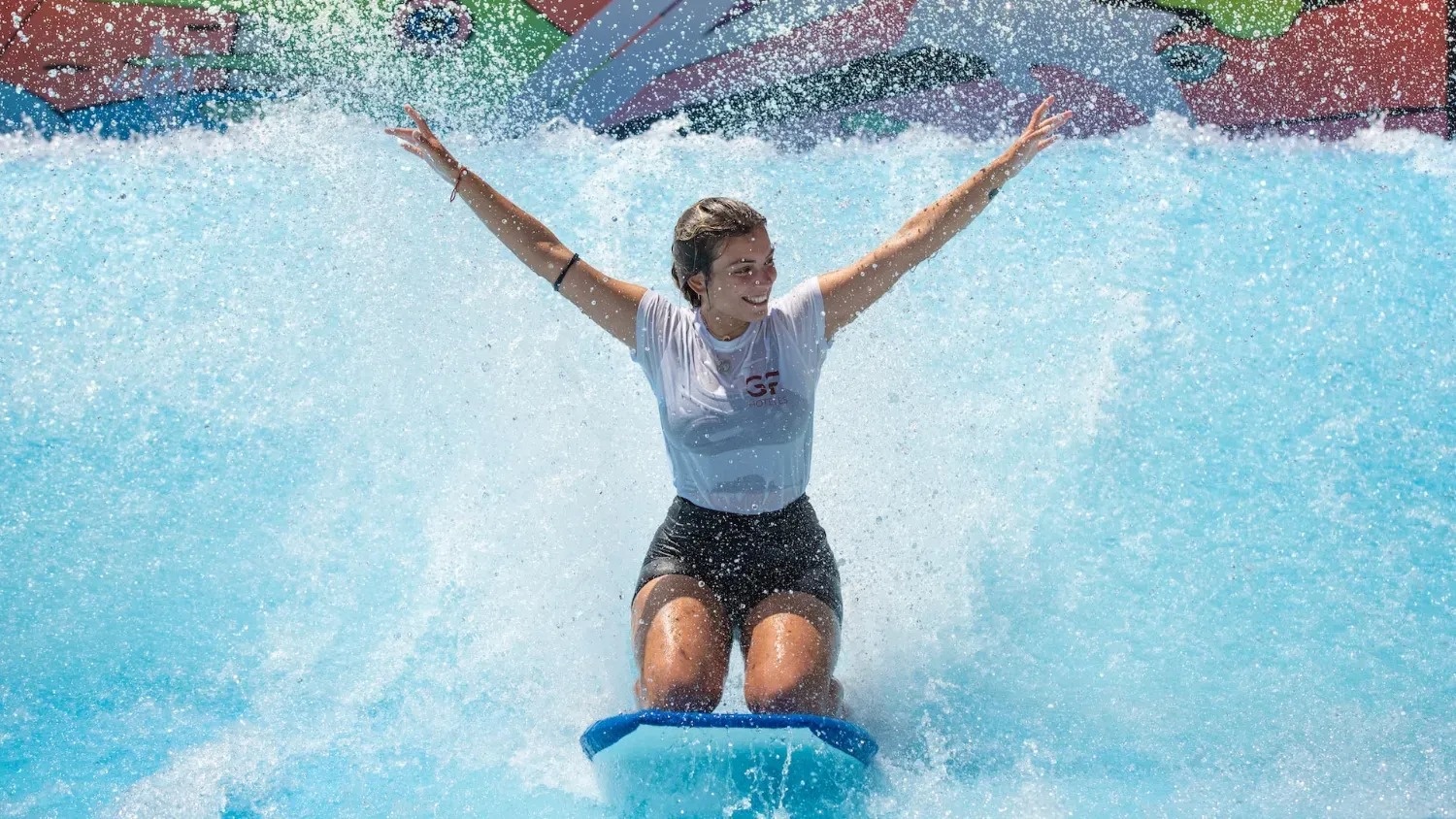 a woman wearing a shirt that says gf is riding a wave