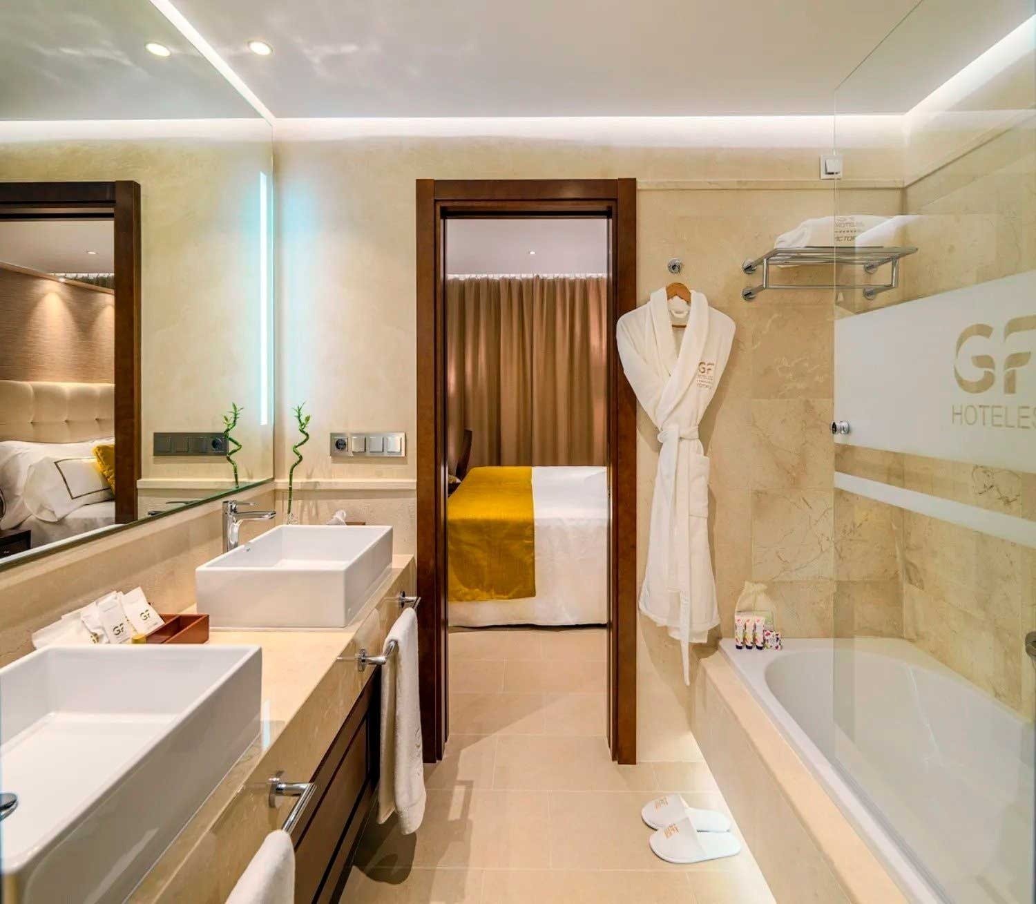 a bathroom with a gf hotel logo on the wall