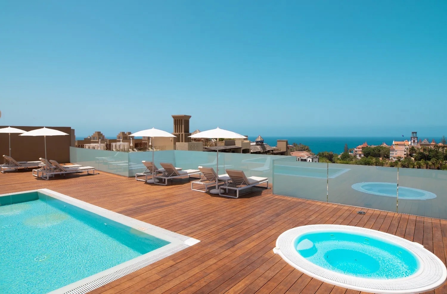 una piscina y un jacuzzi en una terraza de madera