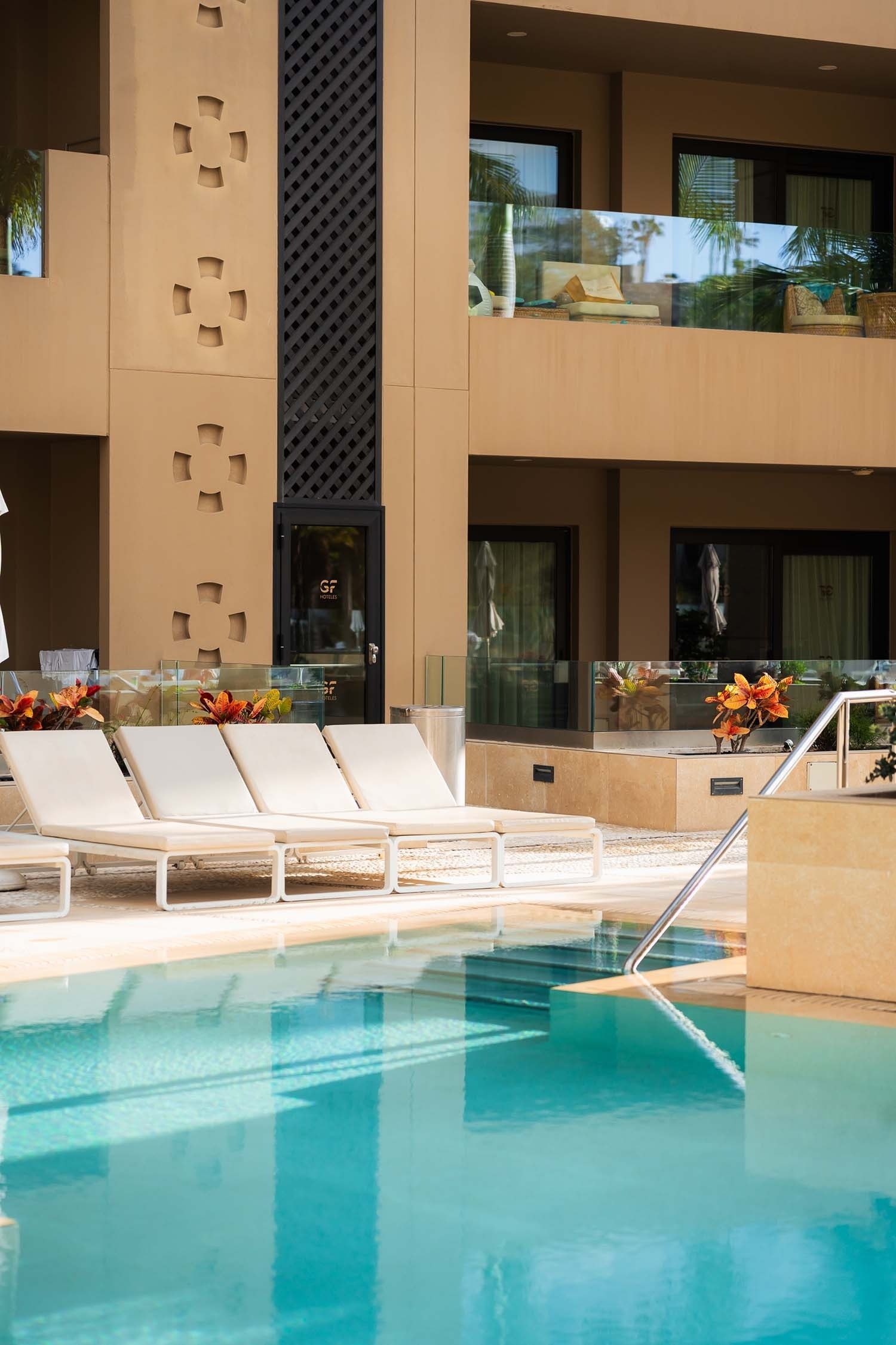 a woman is swimming in a pool on top of a building