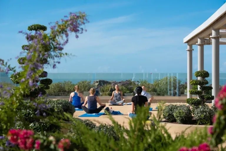 a person 's hand is reaching out into the ocean
