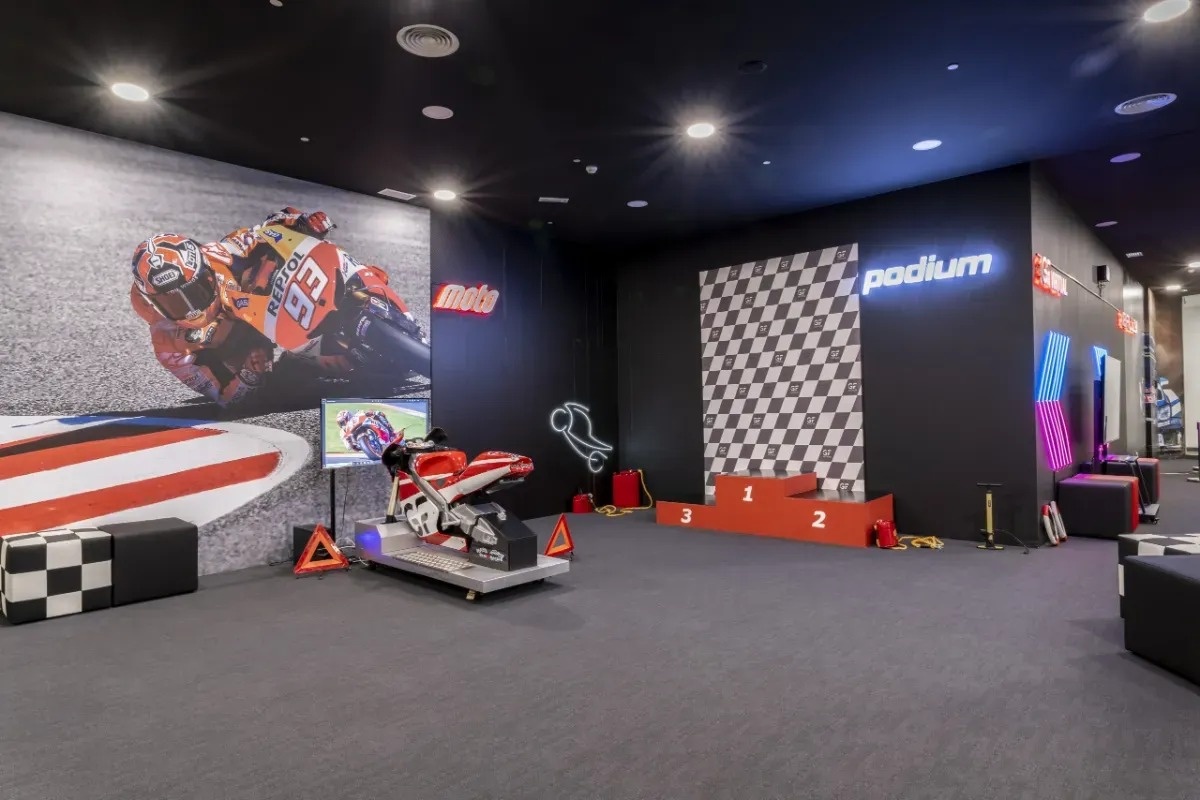 a room with a motorcycle and a sign that says podium