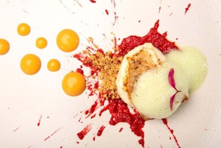 a beach at sunset with buildings in the background