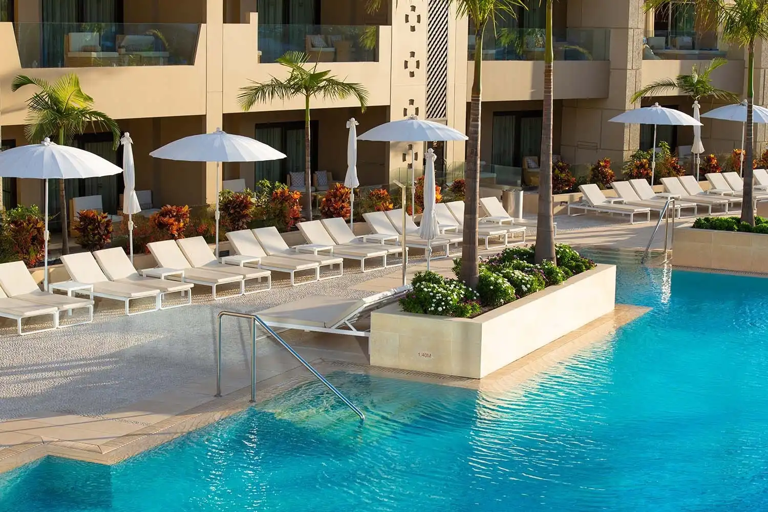 Luxury resort pool with lounge chairs and umbrellas, perfect for GF Victoria GL.