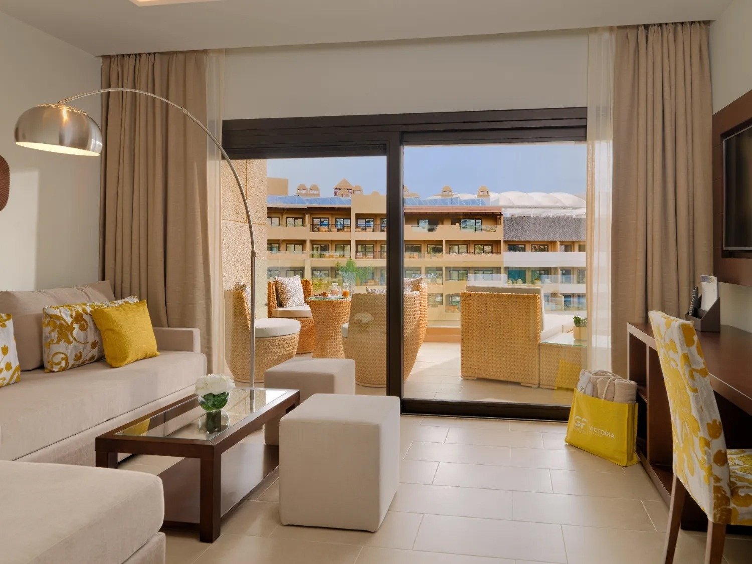 a living room with a sliding glass door leading to a balcony