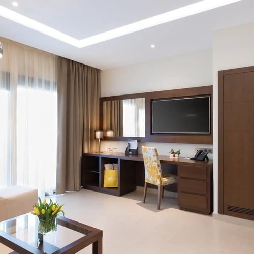 una habitación de hotel con un escritorio y una televisión