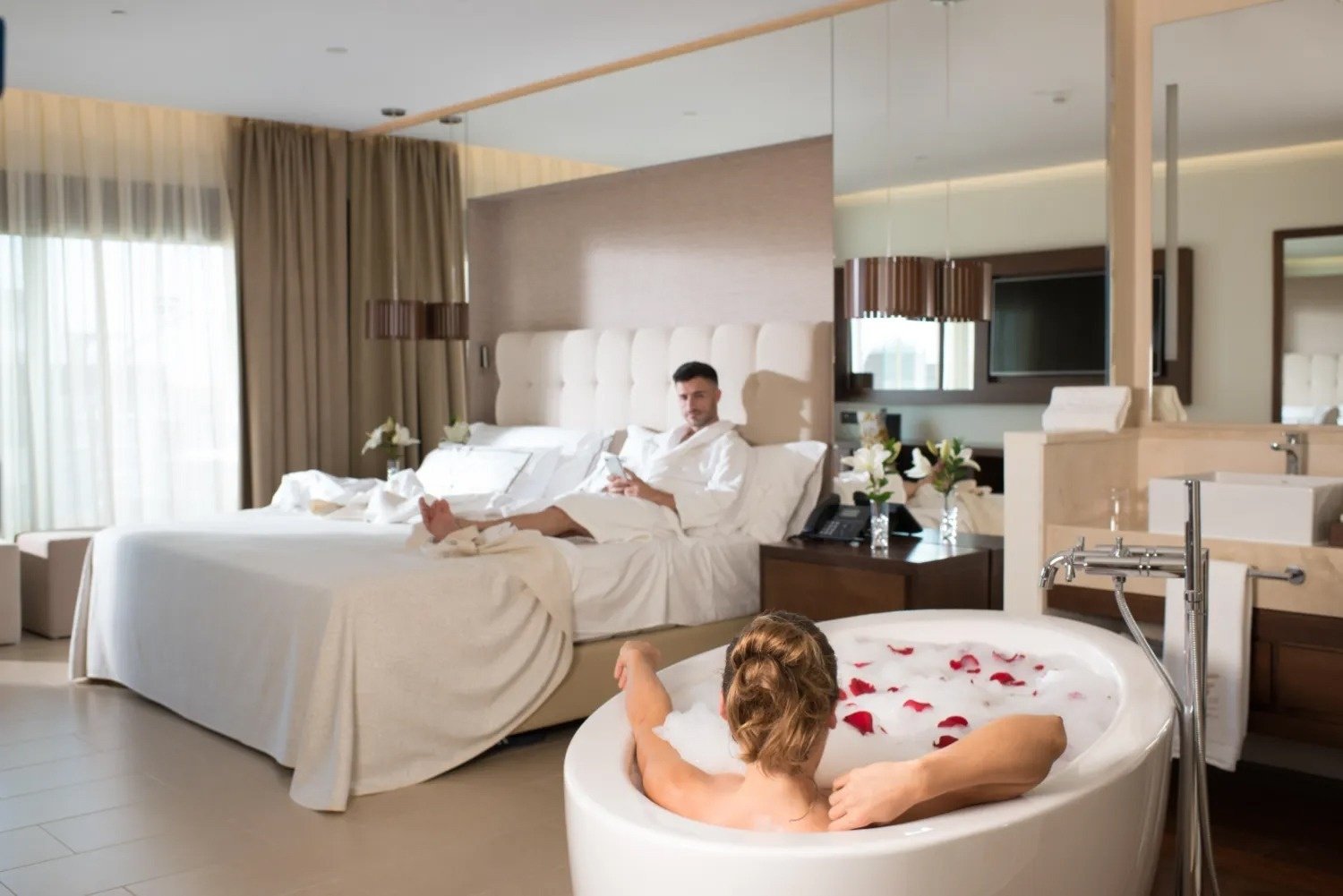 a woman is taking a bath in a hotel room