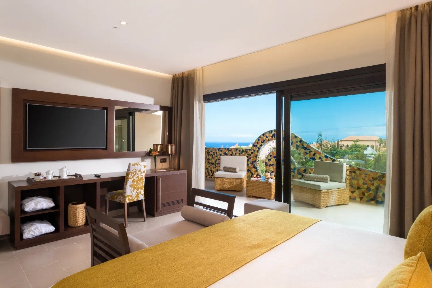 a hotel room with a large bed and a flat screen tv