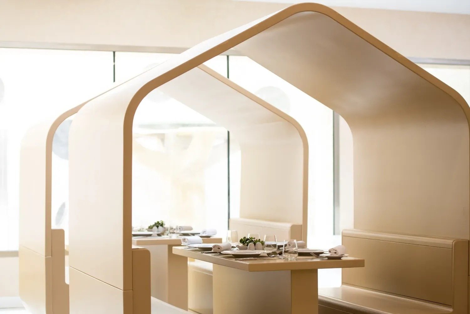 a dining room with tables and chairs and a candle on the table