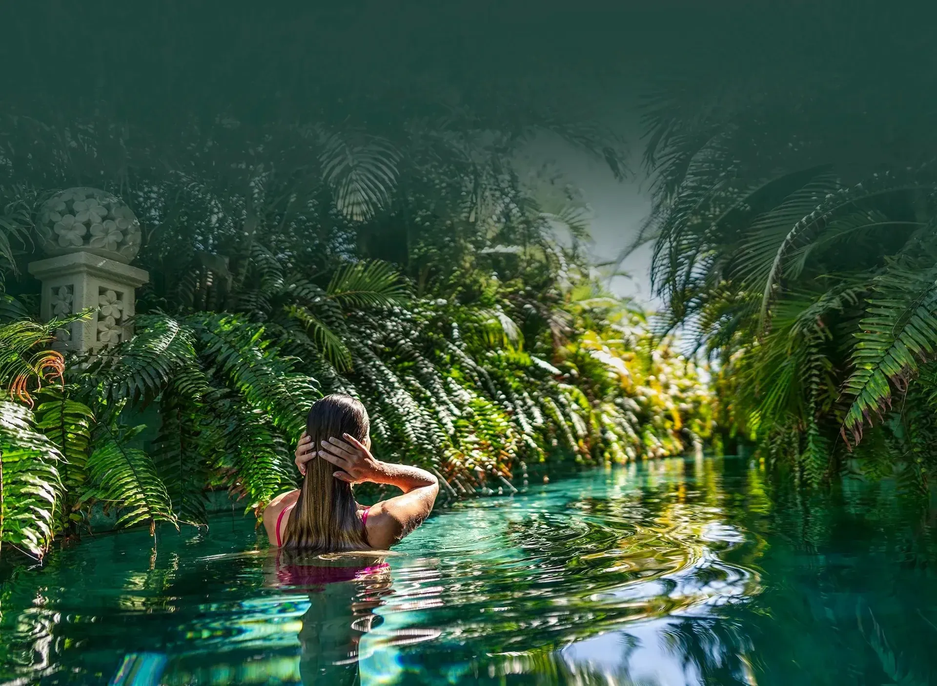Relax in infinity pool surrounded by lush greenery at Royal River Luxury Hotel Tenerife.