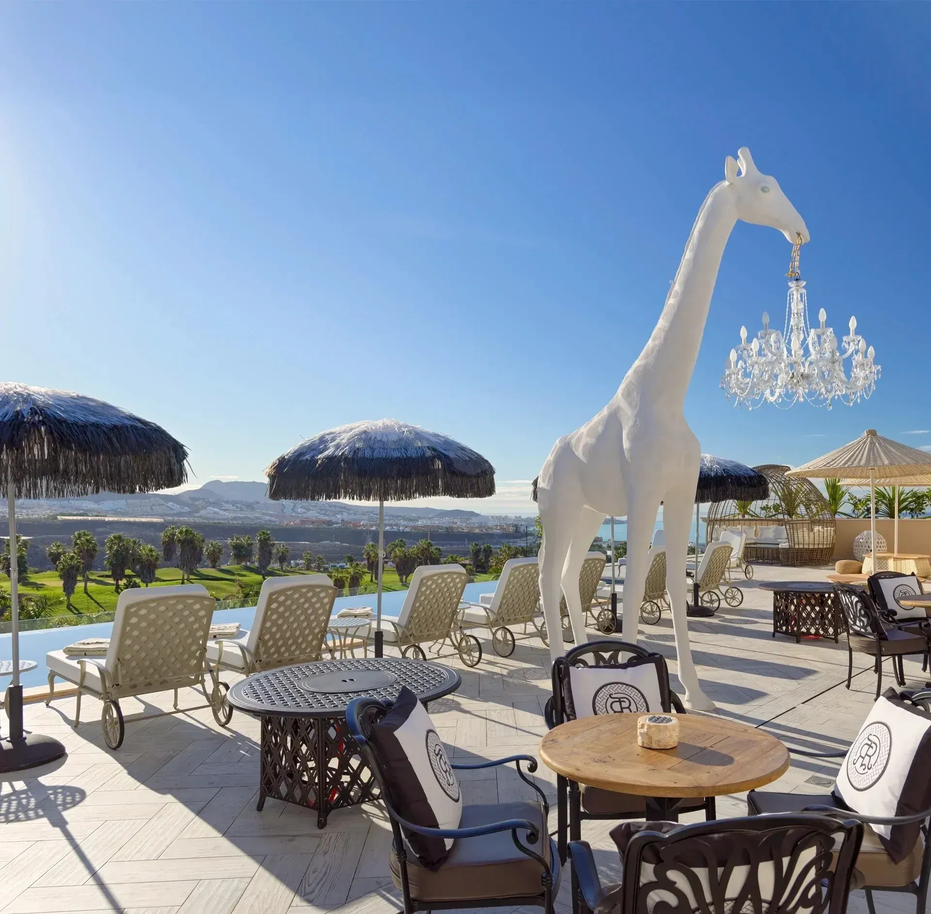 Outdoor dining area with giraffe sculpture at Royal River Luxury Hotel ***** Tenerife.