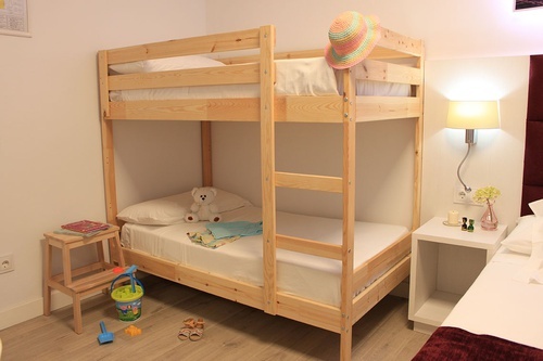 a bunk bed with a teddy bear on top of it