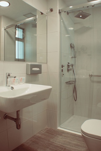 a bathroom with a sink a toilet and a shower