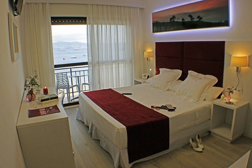 a hotel room with a large bed and a balcony