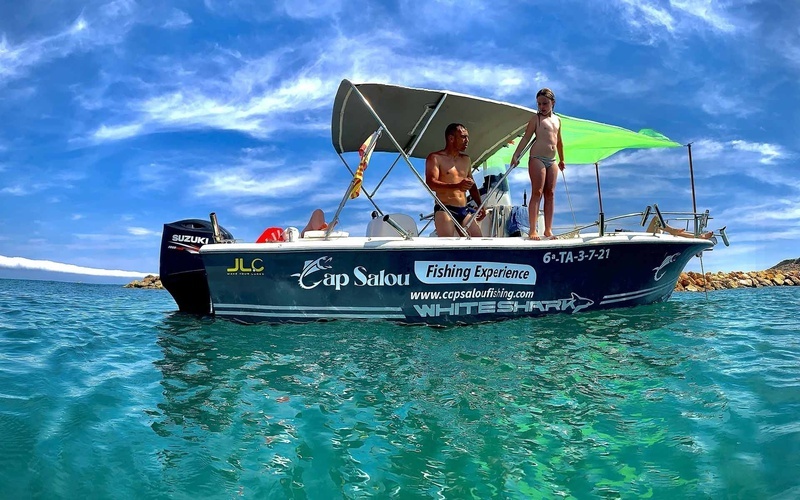 cap salou fishing experience is advertised on the side of this boat