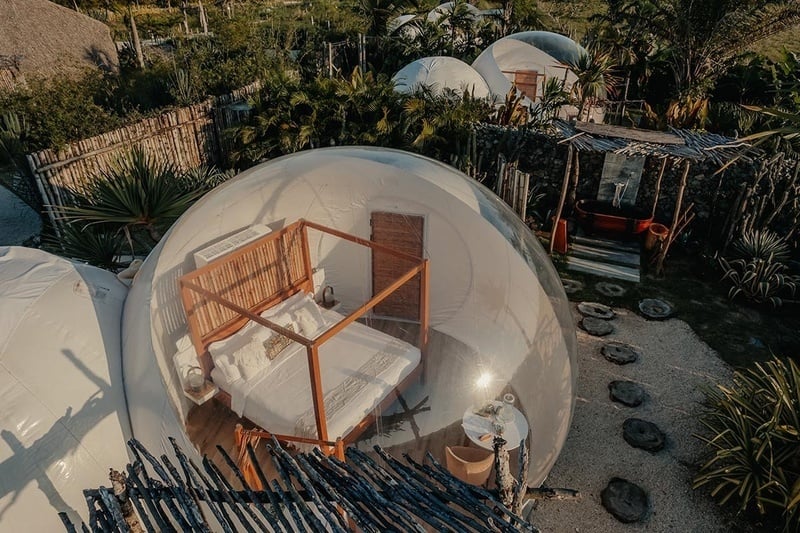 a bedroom in a bubble with a canopy bed