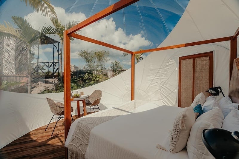 a bedroom with a canopy bed and a table and chairs