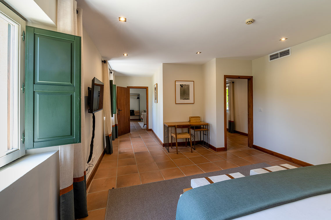 Amplia habitación de hotel con terraza, escritorio y TV, ideal para Hacienda Zorita Wine Hotel.