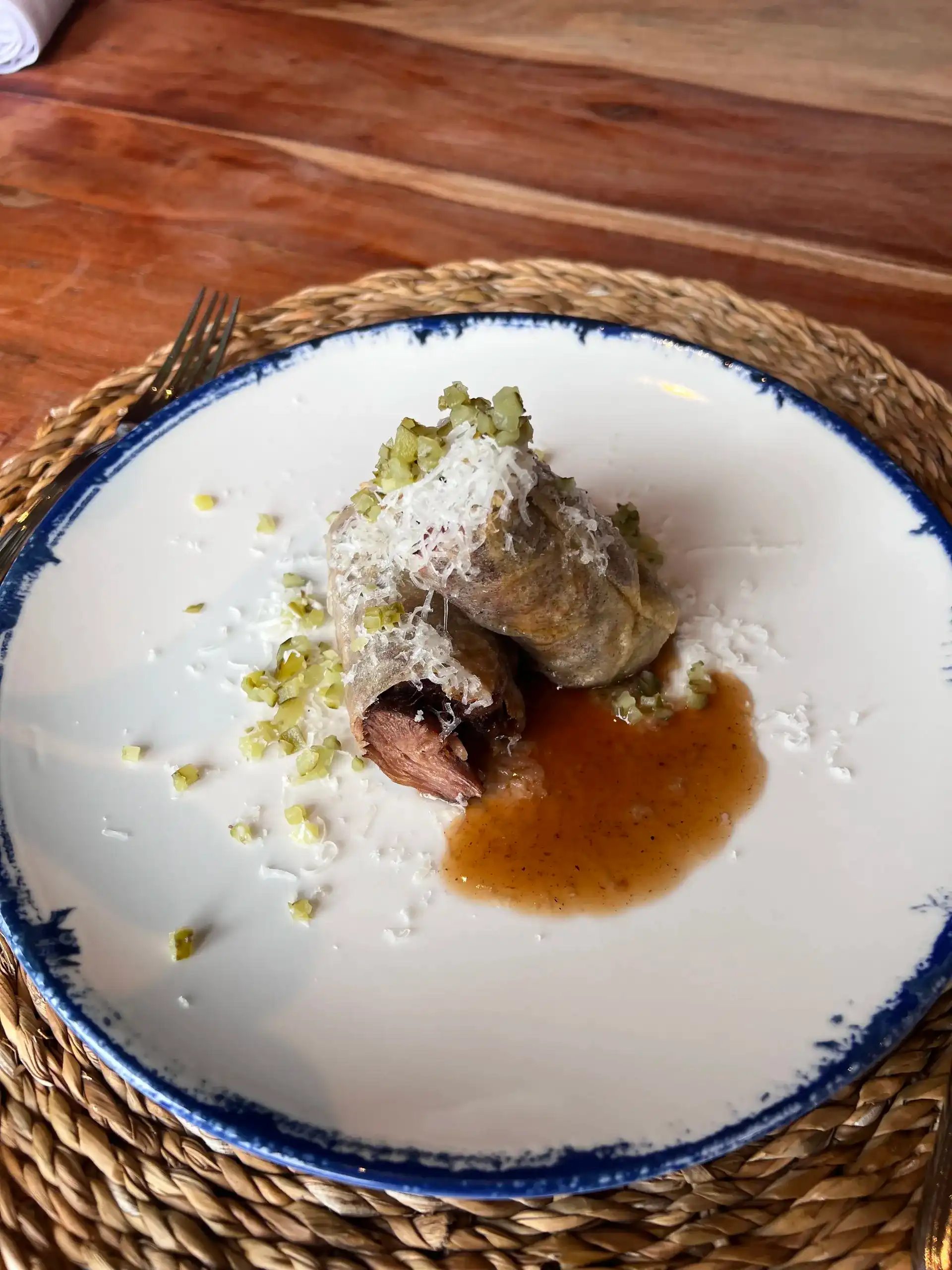 Gourmet dish with shredded cheese and sauce on a plate at a Hacienda Zorita Wine Hotel.