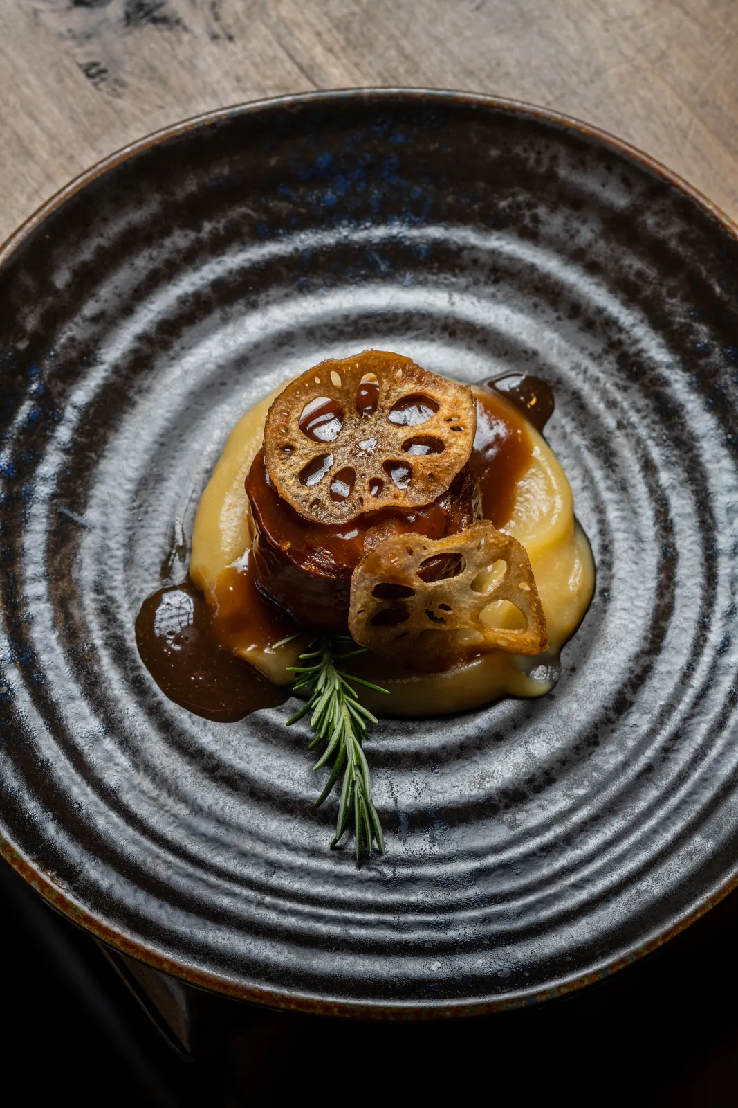 Gourmet dish with lotus root and rosemary, a refined Hacienda Zorita Wine Hotel experience.