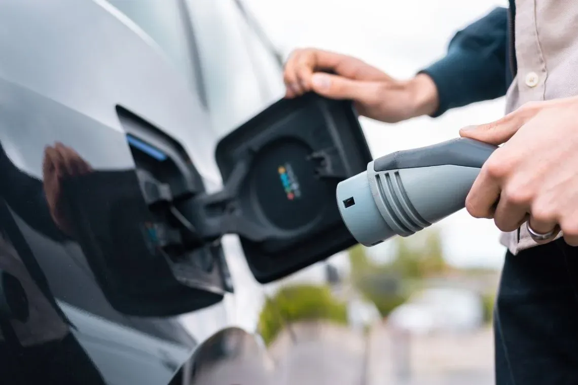 Charging an electric car at a hotel with an EV charger. Horta da Moura