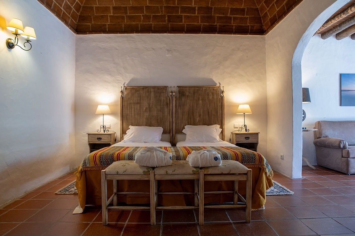 a white building with a red door and a sign that says cottage