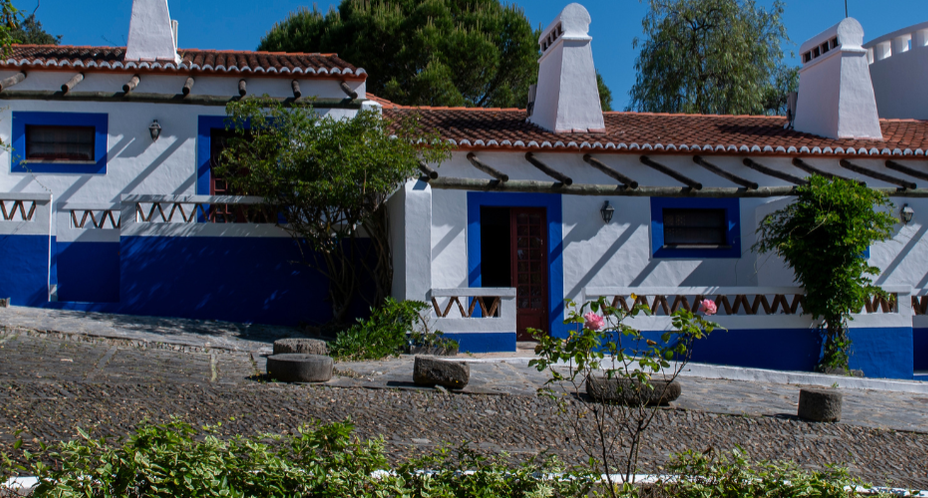 Horta da Moura: charming Portuguese guesthouse with blue and white facade and tiled roof.