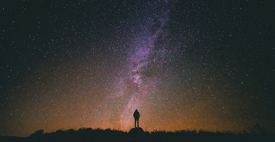 Man stargazing at the Milky Way, perfect Horta da Moura vacation spot.