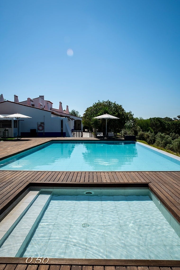 a blue plate topped with a piece of meat and gnocchi