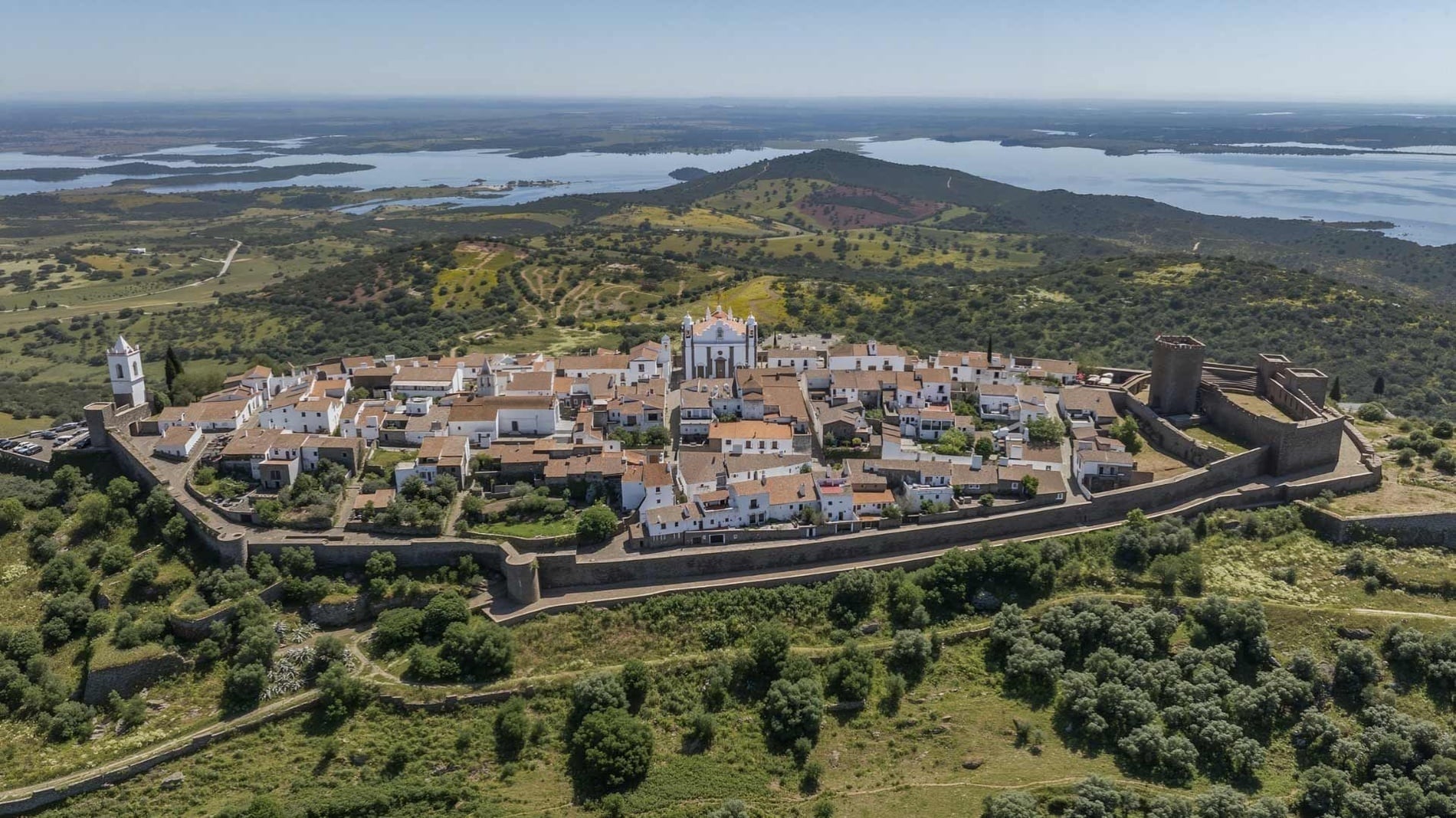Horta da Moura: Historic hilltop village and castle with lake views.