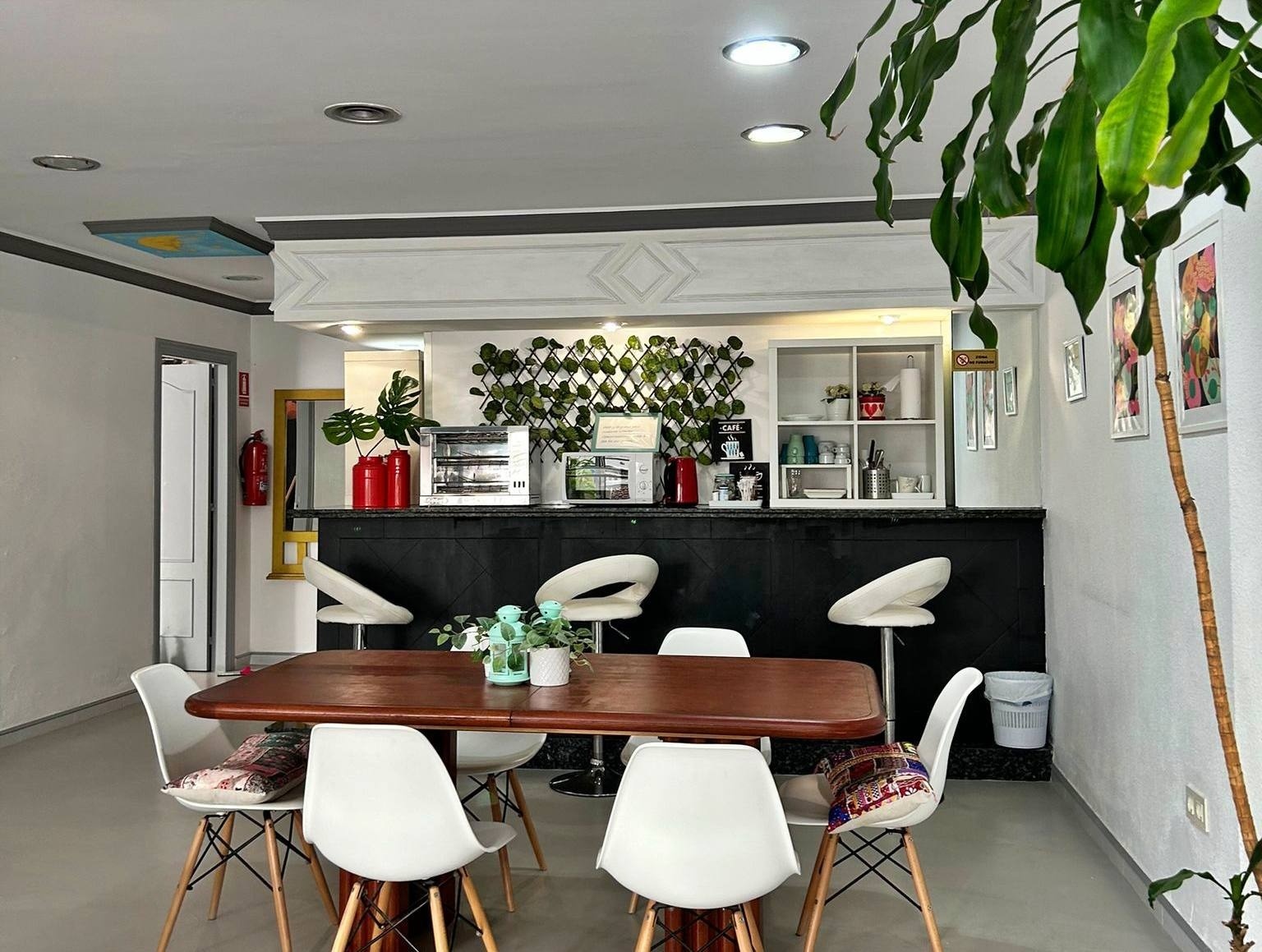 a room with a table and chairs in front of a bar