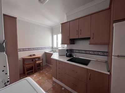 a kitchen with brown cabinets and a white refrigerator