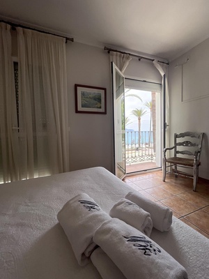 a bedroom with a balcony and towels that say villa